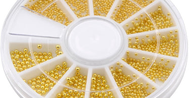 Close-up of 3D Gold Caviar Bullion Beads in assorted sizes, organized on a nail art wheel, showcasing their high-shine metallic finish.