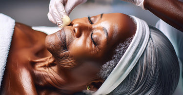 Elderly woman getting waxed in a spa