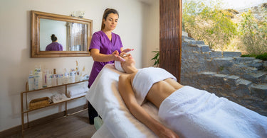 Esthetician giving a facial in a modern spa setting