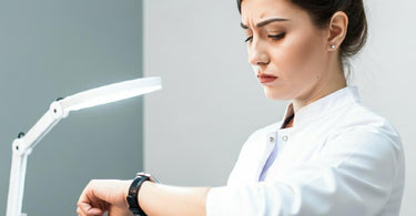 A salon professional checking the time while waiting for a client