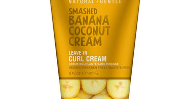 BCL Superfoods Banana Coconut Leave-In Curl Cream product jar displayed against a tropical leaf background for salon and spa retail use.
