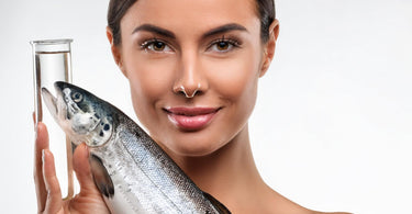 Spa professional holding a test tube with salmon sperm facial serum