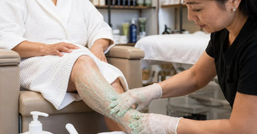 Applying mentholated scrub during a professional pedicure to boost circulation.
