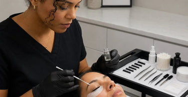 Bottle of pre-treatment primer for lash extensions on a white surface, highlighting the benefits of using it for professional lash artists.