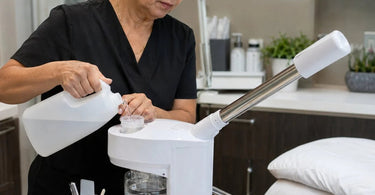 A professional facial steamer being used in a spa setting, highlighting the use of deionized water for clear, mineral-free steam.