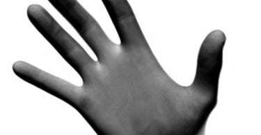Black latex free nitrile gloves in a 10 pack displayed on a wooden background for professional spa and salon use.