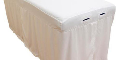 Body Linen Tranquility Microfiber Massage Table Skirt in white, shown draped elegantly on a professional massage table