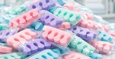 A large bulk package of soft, white disposable foam toe separators for professional salon pedicure services.