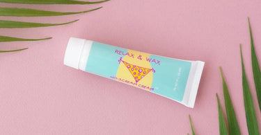Professional waxer applying numbing cream before waxing for a pain-free experience