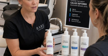 Professional pedicure service with callus softener application on client feet in spa setting
