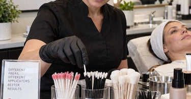 Selection of disposable applicators including lip wands, micro brushes, and spatulas for professional beauty services