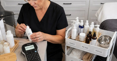 A selection of professional label makers and supplies for spa and salon treatment rooms on a white background