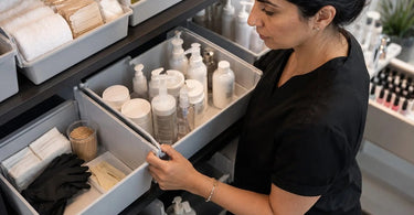 Image showcasing organized spa back bar products with properly sized storage bins and containers