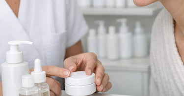 Close-up of a calm, professional esthetician gently applying a soothing moisturizer to a client's chin and mouth area, demonstrating care for sensitive, perioral dermatitis-prone skin.