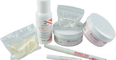 Cuccio Pro Ultra Clear Acrylic Kit Basic with supplies for a professional acrylic nail service on a white surface.