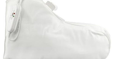ProTool Deluxe Warmer Booties for spa paraffin treatments, shown on a massage table with spa accessories