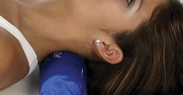 Elasto-Gel Hot and Cold Small Cervical Support Roll 3 inch by 10 inch shown on a blue surface highlighting its therapeutic gel texture.