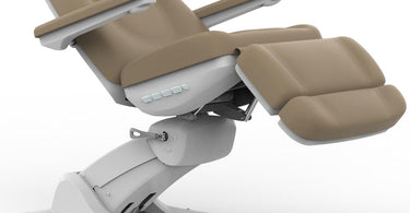 Emelie II Deluxe 4-Motor Medical Spa Chair in Sand color, rotated to show side profile and 240-degree swivel base, set in a luxurious spa environment.