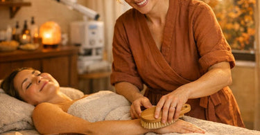 Professional spa dry brushing and clay mask application for fall detox body treatments