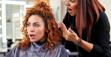 Hair stylist apologizing to a client in a salon
