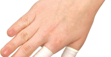 Large latex finger cots for salon and spa professional use on white background