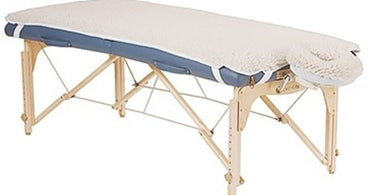 EarthLite Fleece Table Pad shown on massage table, showcasing plush texture and professional spa setting