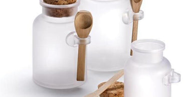 Frosted Apothecary Jars with wooden caps and spoons, perfect for spa retail products like body scrubs and creams.