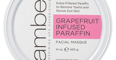 Grapefruit Infused Facial Paraffin 14 oz tub by Amber Products displayed with pink grapefruit slices and spa towels for professional facial treatments.