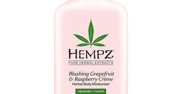 Hempz Blushing Grapefruit and Raspberry Creme Herbal Body Moisturizer in a 17 oz. pink bottle, displayed on a soft background, perfect for spa and salon retail.