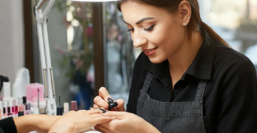 Nail technician attending to a client in a salon setting