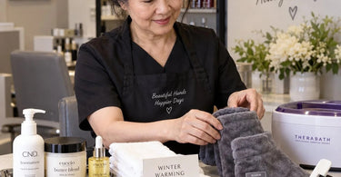 A beautiful display of spa products for a winter warming add-on kit, featuring aromatherapy oils, a towel steamer, and luxurious body care items.