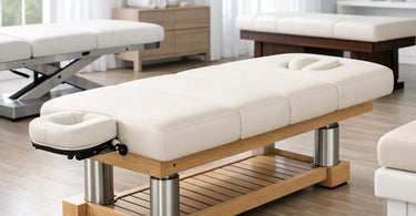 A professional massage table in a spa setting, highlighting its sturdy frame, thick cushioning, and adjustable features.