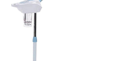 Professional cleaning a facial steamer in a spa setting