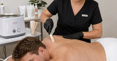 A professional spa setup for large body waxing featuring a large capacity wax warmer, roll-on wax cartridges, and organized tools.