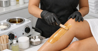 Happy spa staff team bonding and laughing together in a professional treatment room environment