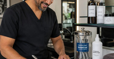 A professional aesthetician filling out a simple and efficient disinfectant log to ensure state board compliance in their spa or salon.