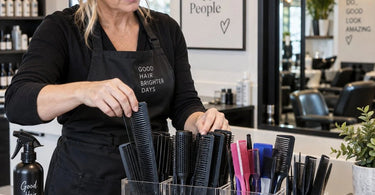 Professional salon workstation with combs organized by service type in labeled drawer dividers