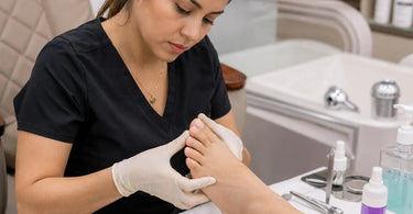 Professional pedicure assessment for fungal risks with magnifying light and gloves