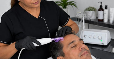 Professional High-Frequency Comb being used on a client's scalp to stimulate hair growth and improve scalp health at a salon.
