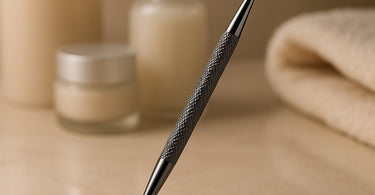 Professional blackhead extractor tool on a spa towel with skincare products