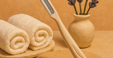 Professional dermaplaning tool on spa towel with skincare products