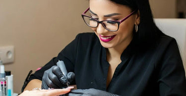 Nail technician providing manicure services in a salon