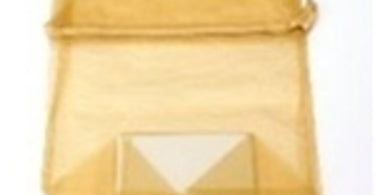 A shimmering large gold organza bag, perfect for retail packaging and organizing spa supplies.