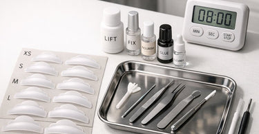 Assorted lash lift supplies including shields, adhesives, and processing lotions arranged on a professional workspace.