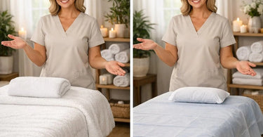 Close up of soft, white spa linens neatly folded next to a package of disposable massage table sheets, illustrating the choice between fabric and disposable options for professional massage therapy.