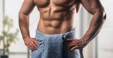 Man wearing a towel around waist at spa