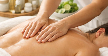 A therapist's hands performing a soothing massage on a client's back in a serene spa setting, symbolizing the healing connection between therapeutic touch and internal wellness.