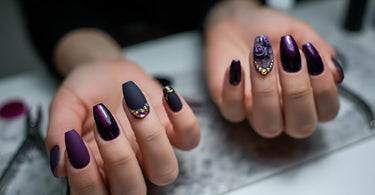Professional dark purple nail design with intricate patterns