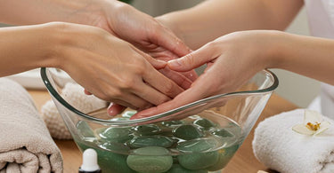 Various healing crystals arranged around spa products on a massage table