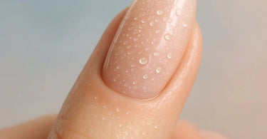 Nail technician performing gel polish application showing proper technique to prevent lifting